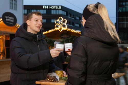 a man and a woman standing next to each other at NH Graz City in Graz
