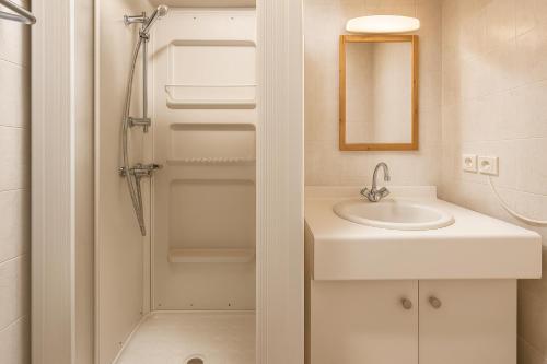 a bathroom with a sink and a shower at White Lodges - Megève center on ski slopes in Megève