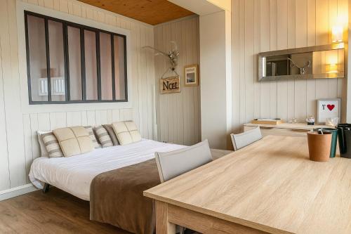 a bedroom with a bed and a table with chairs at White Lodges - Megève center on ski slopes in Megève