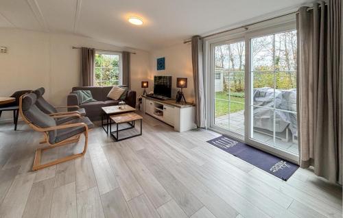 a living room with a couch and a table at Awesome Stacaravan In Goedereede With Wifi in Goedereede