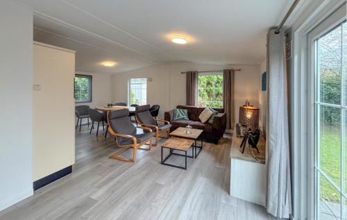 a living room with a couch and a table at Awesome Stacaravan In Goedereede With Wifi in Goedereede