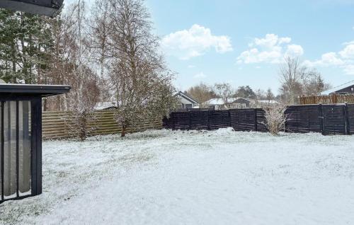 a yard covered in snow with a fence at 3 Bedroom Cozy Home In Korsør in Tjæreby