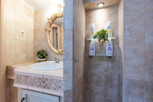 a bathroom with a sink and a mirror at MainAvenue White Tower in Thessaloniki