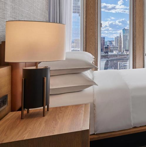 a lamp in a hotel room with a bed and a window at Sheraton Denver Downtown Hotel in Denver