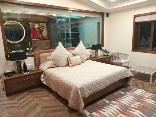 a bedroom with a bed and a large window at Beach villa South Goa in Arossim-Cansaulim