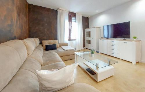 a living room with a large couch and a television at 2 Bedroom Nice Apartment In Castellón De La Plana in Castellón de la Plana