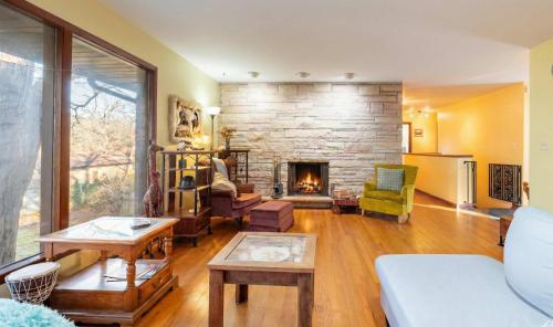 a living room with a fireplace and a couch at Spacious 4BR Home with BBQ Yard Near Golf Course in Rockford