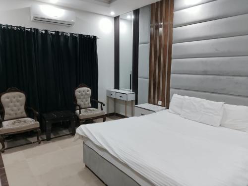 Postel nebo postele na pokoji v ubytování Grand Villa by Oslo Rezidor