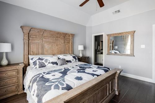 a bedroom with a large bed with a wooden headboard at Welcome to enjoy your home in Dallas