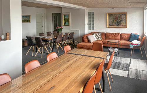 a living room with a wooden table and a couch at 7 Bedroom Stunning Home In Samsø in Kolby Kås