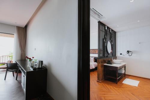 a bathroom with a sink and a mirror at Pandora Beach Mui Ne Retreat in Mui Ne