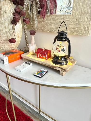 a table with a shelf with a lantern on it at La Chambre des Secrets by Leslodgespa - Escapade romantique proche de Bâle avec terrasse privée in Hésingue