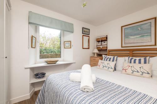 a bedroom with a large bed and a window at The Mini Mansion - Elie in Elie