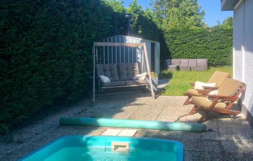 a swing with a couch and chairs in a backyard at Cozy Home In Scharendijke With Private Swimming Pool, Can Be Inside Or Outside in Scharendijke