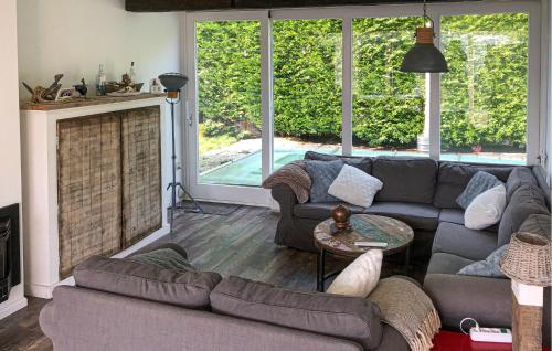 a living room with a couch and a fireplace at Cozy Home In Scharendijke With Private Swimming Pool, Can Be Inside Or Outside in Scharendijke