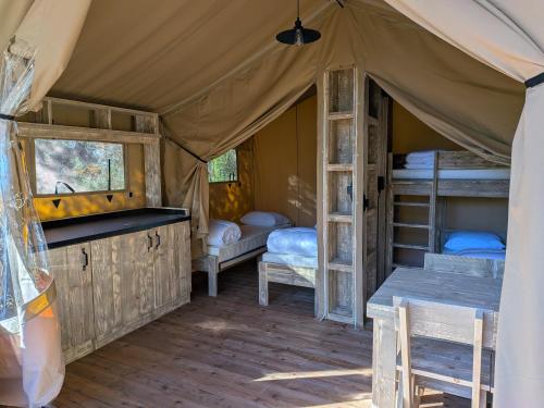a room with bunk beds in a tent at Camping le Cézanne Montagne Sainte-Victoire in Puyloubier