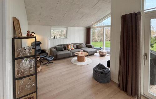 a living room with a couch and a table at 3 Bedroom Awesome Home In Haderslev in Kelstrup Strand