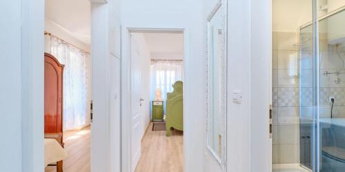 a hallway with a glass door leading to a bathroom at Pino 1 in Veli Lošinj