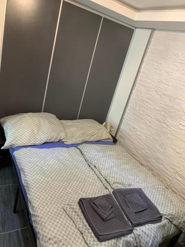 a bed with two towels sitting on top of it at Lipno Pearl Terasa in Lipno nad Vltavou