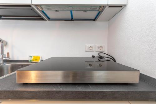 a stainless steel counter in a kitchen with a sink at Sweet Loft in Sottoguda