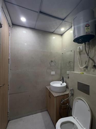a bathroom with a toilet and a sink at Your heaven in Greater Noida
