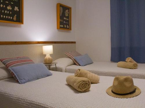 a room with three beds with hats on them at Sunset Arena Beach by HelloApartments in Puerto de Santiago