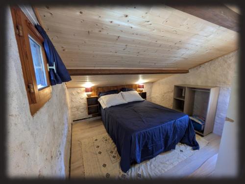 a bedroom with a bed in a small room at Le Mas des Condamines in Canet