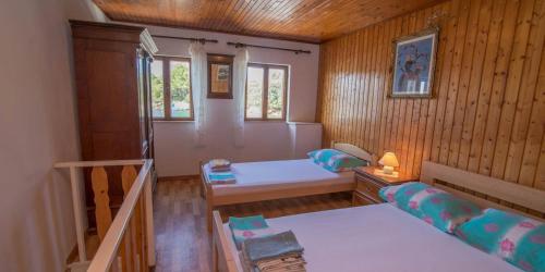 a small room with a bed and a staircase at JOSIP A3 in Nerezine