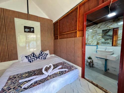 een slaapkamer met een bed en een wastafel in een kamer bij Ban Hao Riverstay Muang Fuang in Muang Fuang