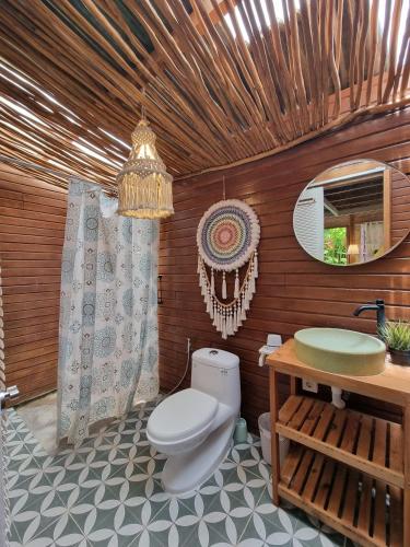 a bathroom with a toilet and a sink at Tiny House Bali in Kerobokan