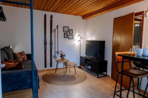 a living room with a couch and a table at AlpinRetro-Apartment I Stylisch & zentral I See & Berge I Luzern I Zürich I Stoos I Rigi in Schwyz