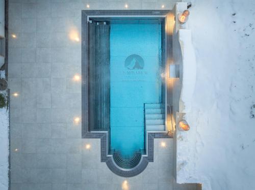 a swimming pool with stairs and lights in a building at Mirabeau Etoile in Zermatt