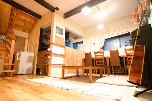 a kitchen and dining room with a table and chairs at tabibito bed byme in Sapporo