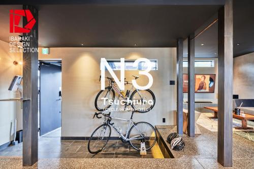 a bike is hanging on a wall in a lobby at N3 Tsuchiura CYCLE HOME HOTEL in Tsuchiura