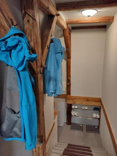 a hallway with blue shirts hanging on a wall at Apartmány Arin in Jáchymov