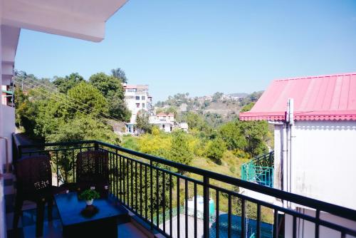 a balcony of a house with a view of a pool at Dhananjay home stay in Dharampur