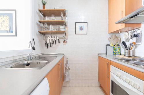 a kitchen with a sink and a counter top at Luxury, Frontline Burriana Beach, Nerja in Nerja