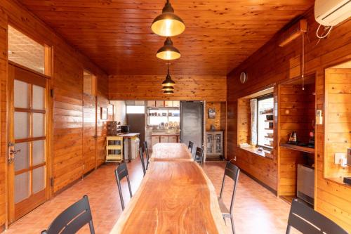 a dining room with a long table and chairs at Refugio del Café - Vacation STAY 92035v in Iwaki