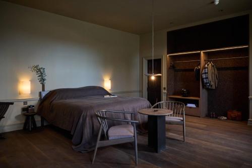 En eller flere senge i et værelse på The Coach House Lodges at Denton Reserve