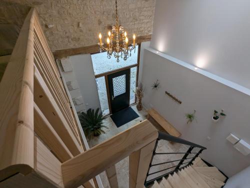 an overhead view of a staircase with a chandelier at Les Pierres Douces in Champniers