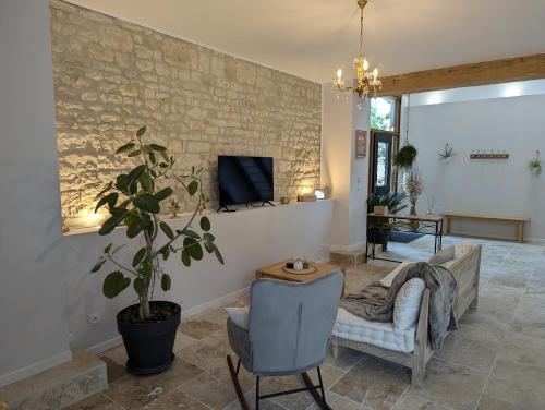 a living room with a couch and a chair at Les Pierres Douces in Champniers