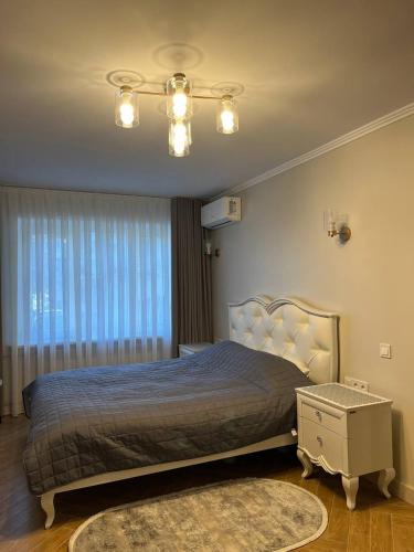 a bedroom with a large bed and a window at Loading Apartments in Chernivtsi