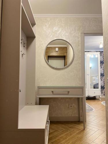a bathroom with a mirror and a dressing table at Loading Apartments in Chernivtsi