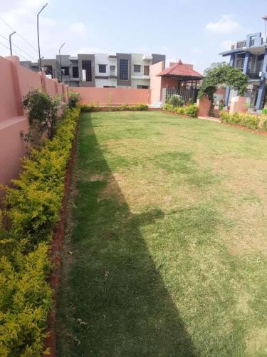 een grasveld met gebouwen op de achtergrond bij The time's stay in Nāi