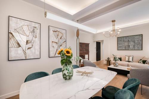 un soggiorno con un tavolo con un vaso di fiori di Mk Luxury Apartment a Nauplia