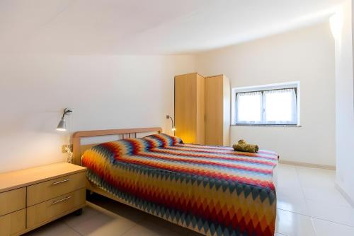 En eller flere senge i et værelse på Spiaggia E Relax Calasetta