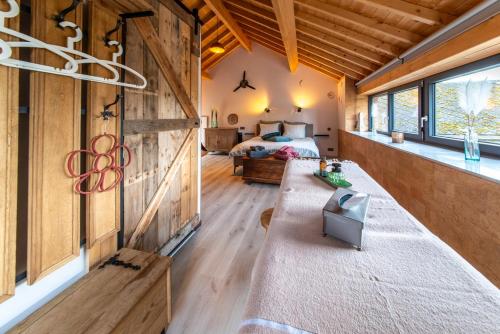 a bedroom in a log cabin with a bed at L'école Buissonnière - Suite Bien-être 2 personnes in Vielsalm