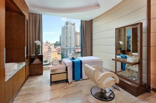 a hotel room with a bed and a window at The Reverie Saigon Residential Suites in Ho Chi Minh City