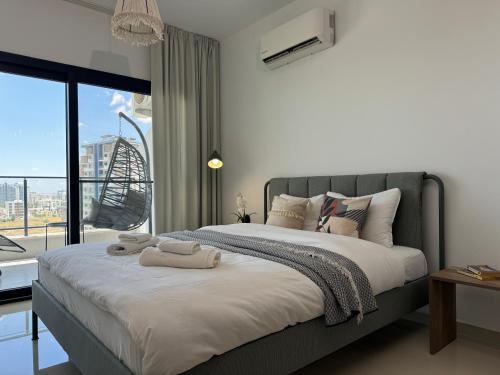 a bedroom with a large bed with towels on it at Seaview stylish one bedroom apartment in Caesar Romulus 88 in Bahçeler