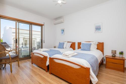 a bedroom with two beds and a balcony at Apartment Atlantico, Town Centre in Tavira